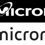 Linus Sebastian from Linus Tech Tips standing with a Micron engineer in a cleanroom, examining a silicon wafer during the Micron factory tour.