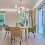 A bright, staged living room with neutral walls and furniture pulled away from the walls, demonstrating a key staging secret for real estate for sale.