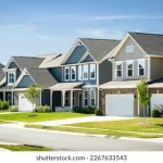 A row of suburban houses with one house faded into a shadow, representing shadow inventory